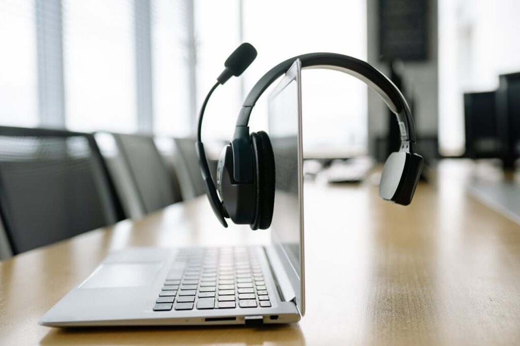 pexels-photo-8866726 A Black Headset Microphone Hanging on the Laptop Screen
